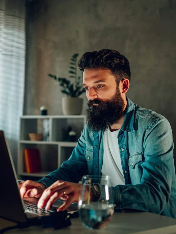 an-operating-data-security-worker-is-working-from-his-darkened-home-office-remotely-.jpg